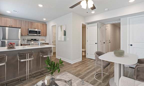 A modern kitchen with stainless steel appliances and wooden cabinets.