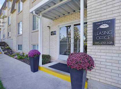 A leasing office sign is on the side of a building.