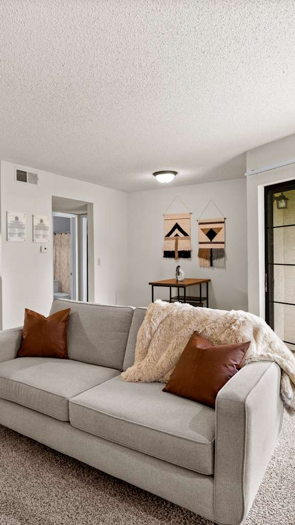 A bedroom with a large bed and a ceiling fan.