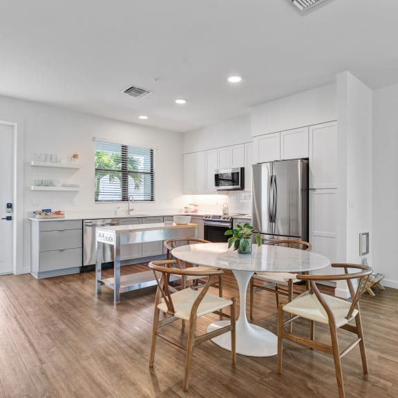 a kitchen and dining room with a table and chairs at Odyssey, Fort Myers, FL, 33905