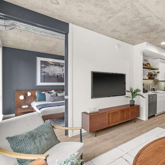 A modern living room with a white couch and a wooden coffee table.