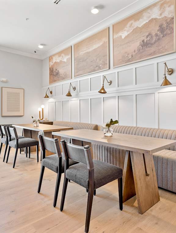 A dining room with a long table and chairs.