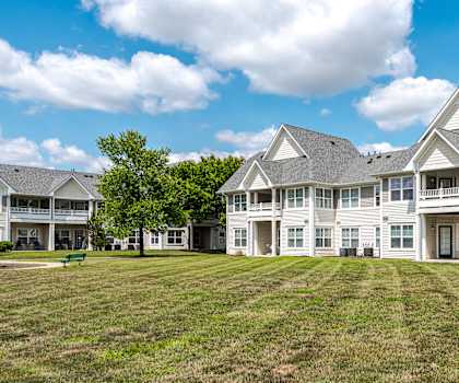 the yard in front of a large house