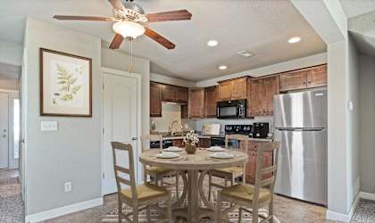 A kitchen with a table and chairs in the middle of the room.