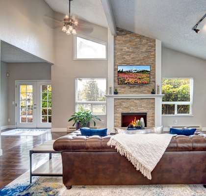 a living room with a leather couch and fireplace at Brookstone, Washington, 98198