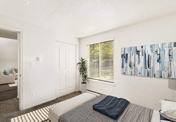 a bedroom with a bed and a window and a painting on the wall