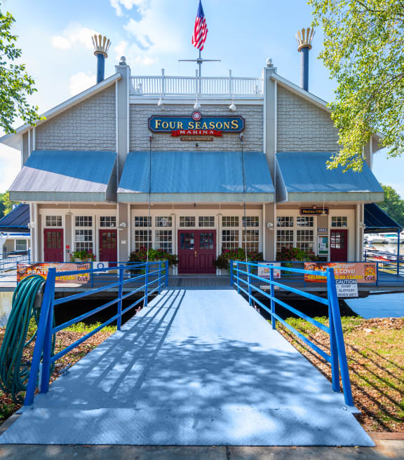 a boat dock with a building with boats on the water