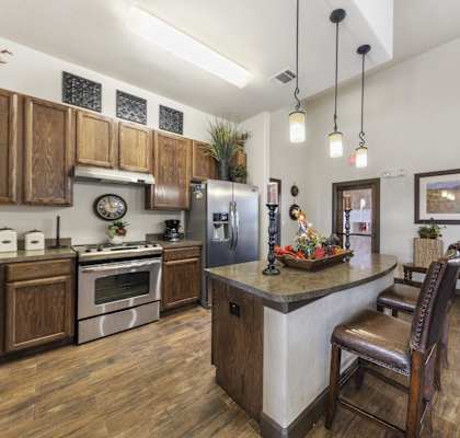 a kitchen with stainless steel appliances and a island with a counter top
