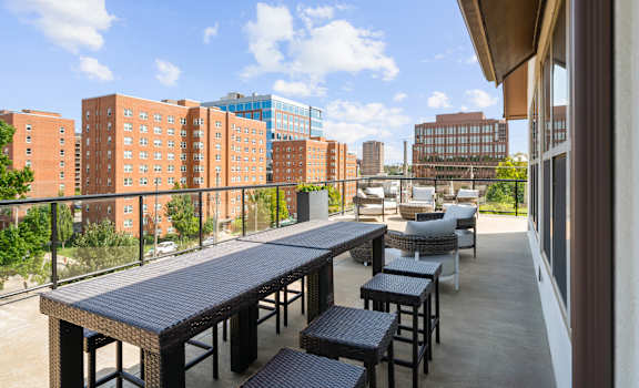 A patio with a table and chairs overlooks a cityscape.at The Dorset, Kansas City, MO