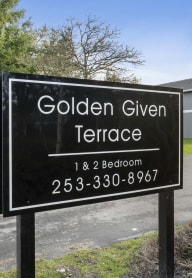 a sign for golden give terrace in front of a building