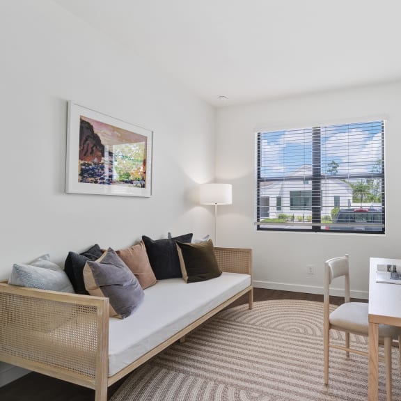 a living room with a couch and a desk and a window at Odyssey, Fort Myers, FL, 33905