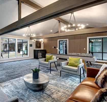 a living room with couches and chairs and a fireplace