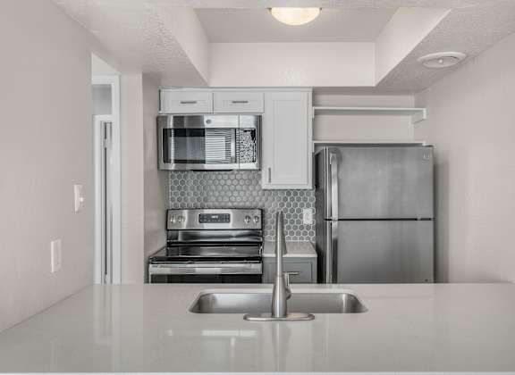 a kitchen with stainless steel appliances and a sink