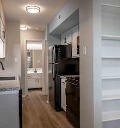 a renovated kitchen with black appliances and white cabinets