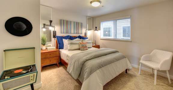 a bedroom with a bed and a desk and a chair