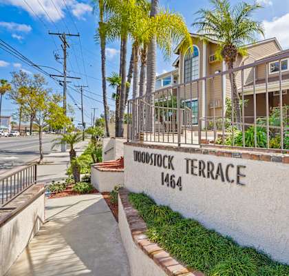 A white wall with the words "Woodstock Terrace" and the number "1464" on it.
