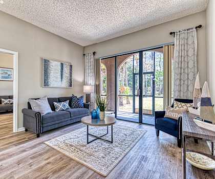 an open living room with a sliding glass door to a patio