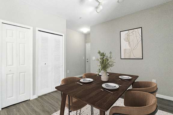 A dining room with a brown table and chairs.