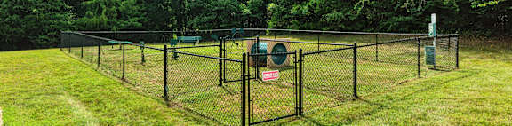 A fenced area with a sign on it.