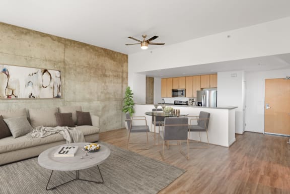 Living room with concrete accent wall and kitchen at Vendome Place, San Jose, 95110
