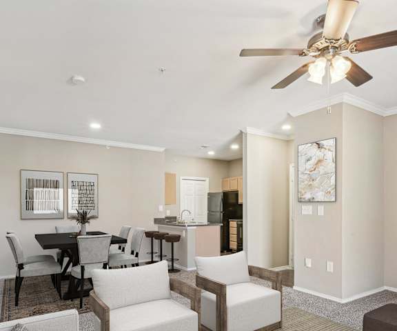 a living room with couches and chairs and a tv at TalaVera Apartments, Texas