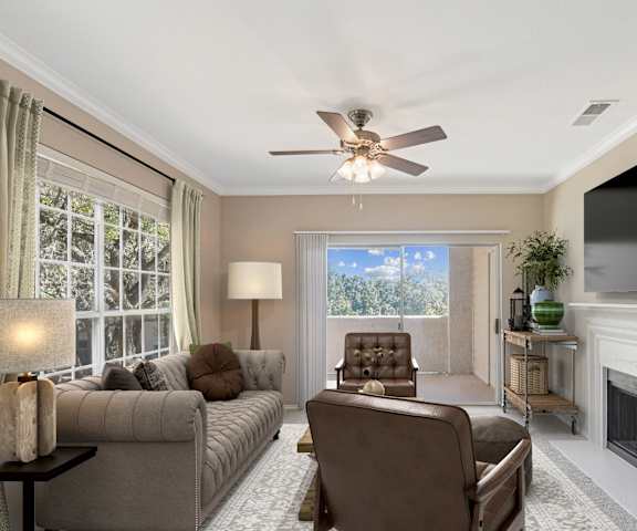 a living room with couches and chairs and a tv