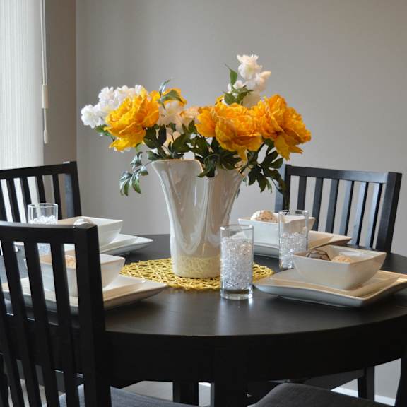 A table with chairs and a plant on it.