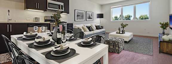 A modern dining room with a white table set for six.