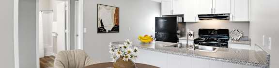 A modern kitchen with a dining table and chairs.