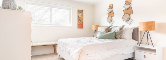 a bedroom with white walls and a white bed with white bedding and pillows at The Bodhi at Island Creek Village, Duxbury, MA 02332