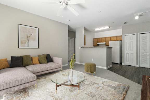 A living room with a couch, a coffee table, and a rug.