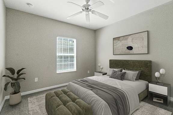 A bedroom with a large bed and a ceiling fan.