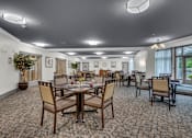 Thumbnail 4 of 54 - A large room with tables and chairs and a carpet.