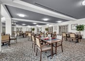 Thumbnail 6 of 54 - A large room with tables and chairs.