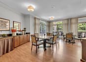 Thumbnail 10 of 54 - A dining room with a table set for six.