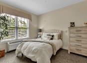 Thumbnail 22 of 54 - A bedroom with a large bed and a dresser.