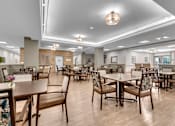 Thumbnail 28 of 54 - A large room with tables and chairs.