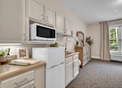 Thumbnail 35 of 54 - A kitchen with white appliances and cabinets.