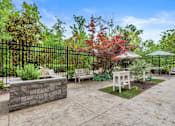 Thumbnail 44 of 54 - A patio with a table and chairs surrounded by a black fence.