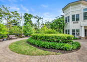 Thumbnail 47 of 54 - A white house with a landscaped front yard.
