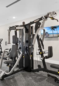 a gym with exercise equipment and a flat screen tv