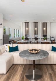 a large living room filled with furniture and chandeliers