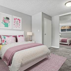 A bedroom with a large bed and a wardrobe.