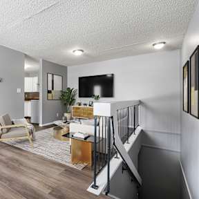 A living room with a staircase leading to the upper floor.