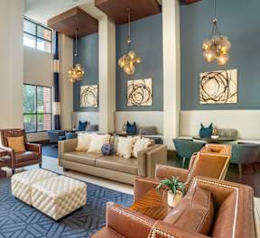 A modern living room with a large sofa set and a wooden coffee table.