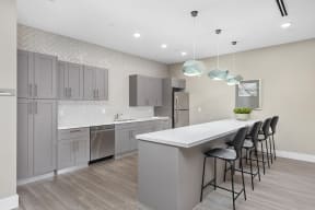 a kitchen with gray cabinets and a white counter top