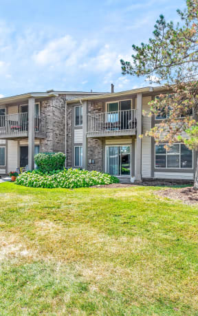 an apartment building with grass and trees in front of it at Edge At Farmington Hills - Farmington Hills, MI, Farmington Hills, 48334