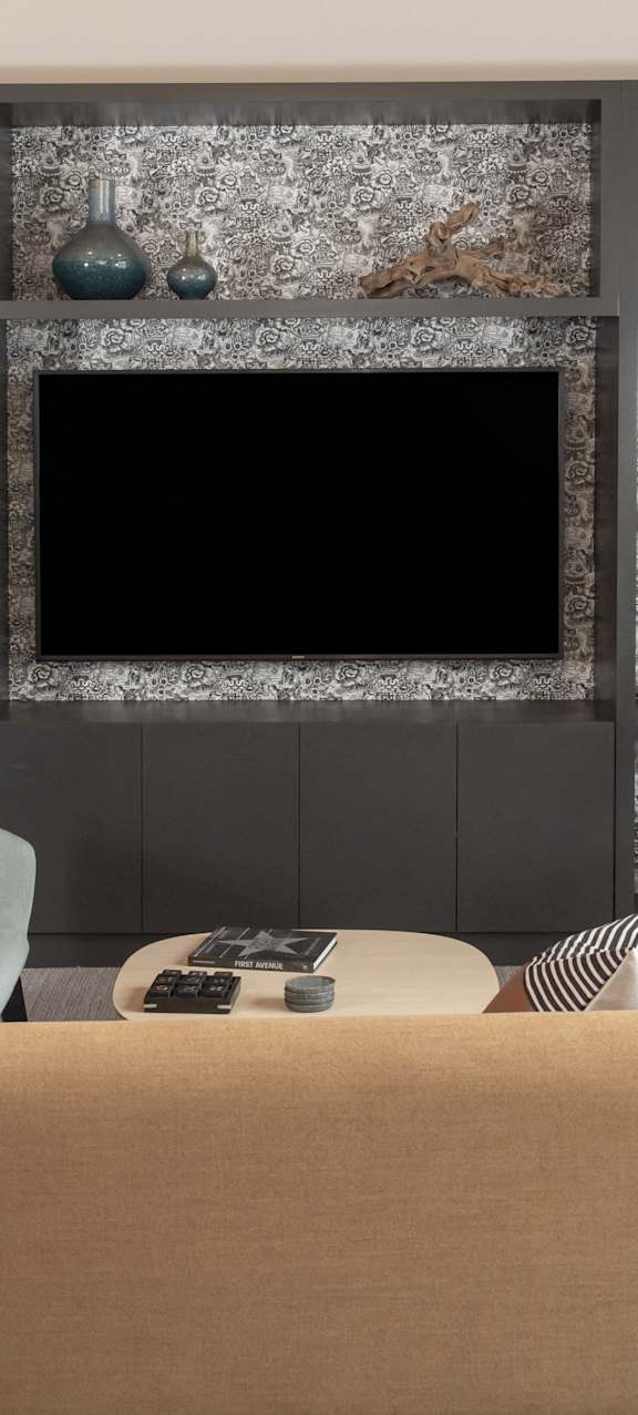 A living room with a television and a sofa.