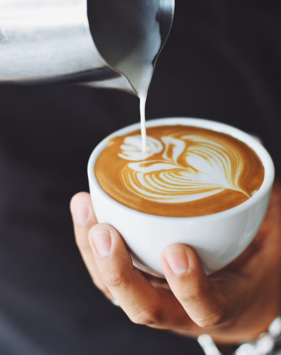 a man holding a cup of coffee