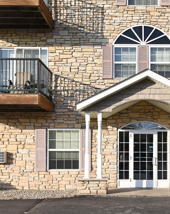 the front of a brick house with a white garage door